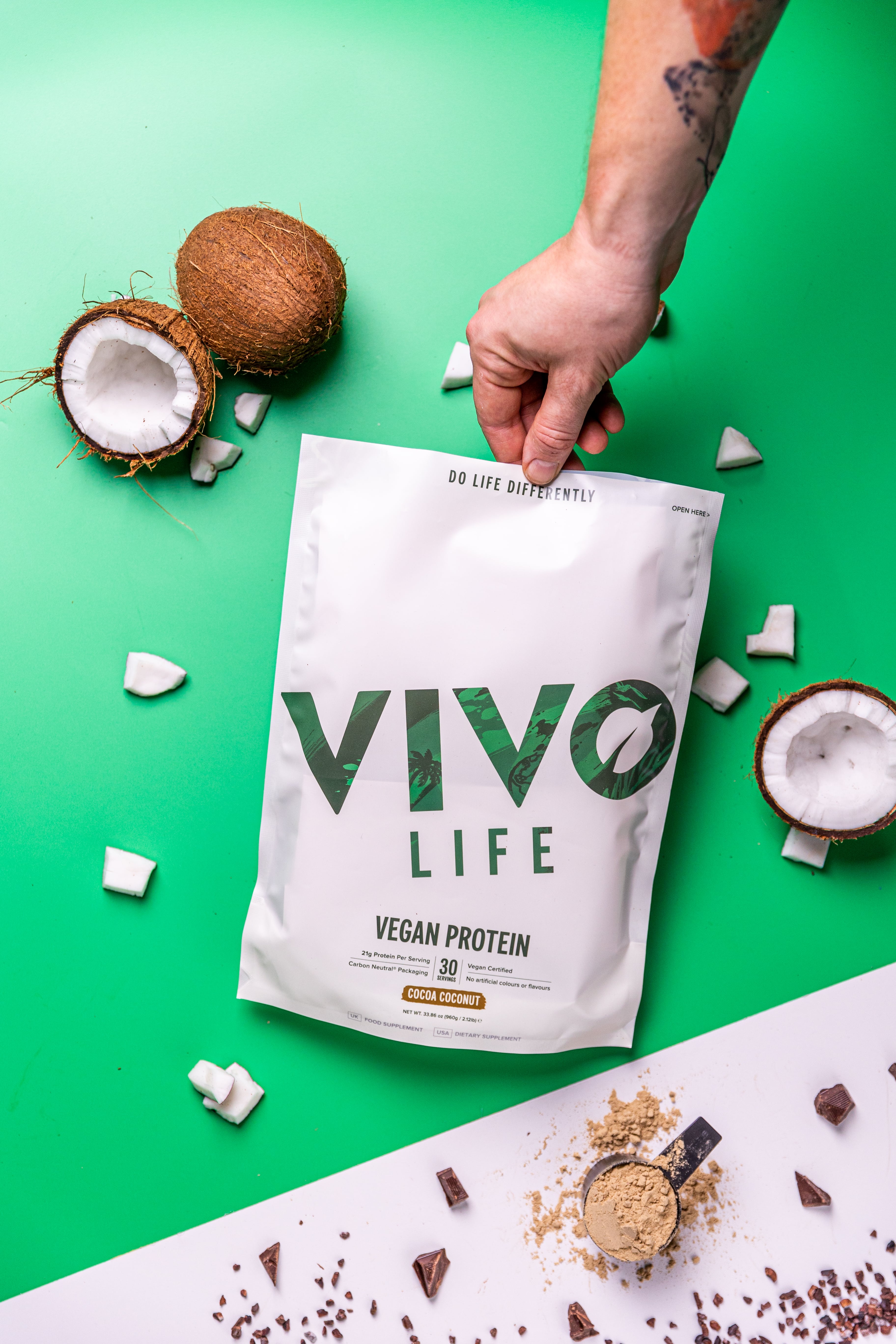 Futureproof October 23 - Vegan Protein - Flatlay with coconut on dark green and white background 2-min
